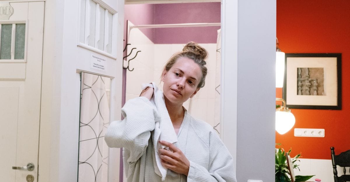 A woman towel-drying after a shower