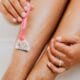A pink razor shaving a leg in close-up