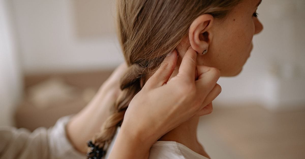 A woman braiding her hair