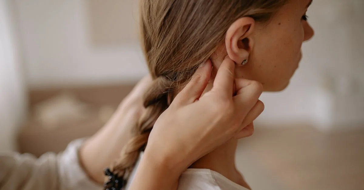 A woman braiding her hair