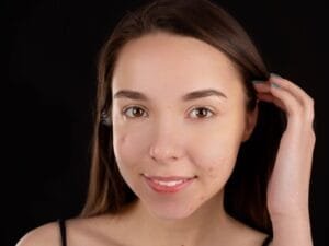A woman with small clear patches on her face