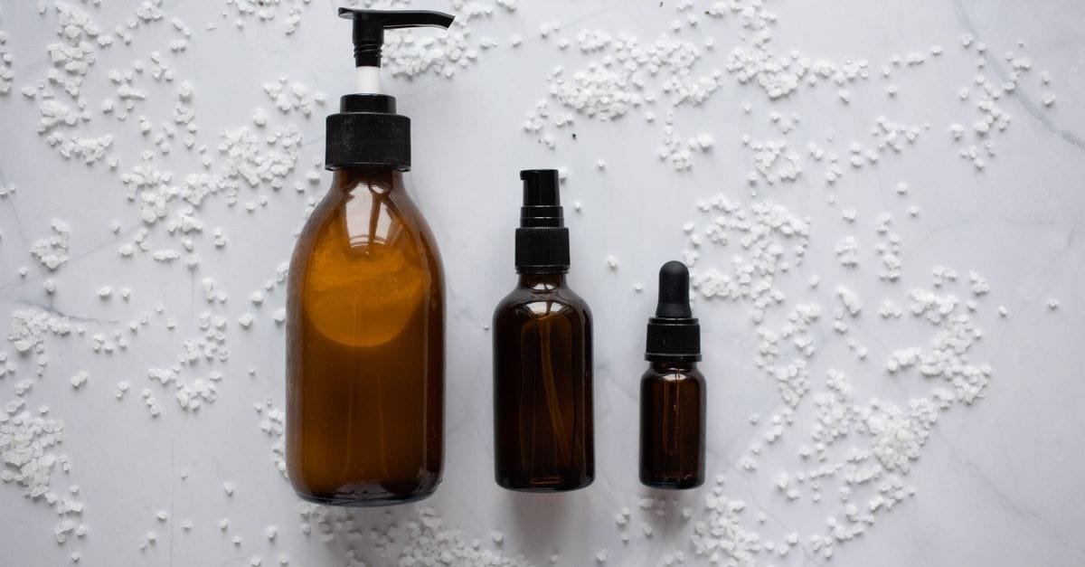 Amber pump and dropper bottles on white