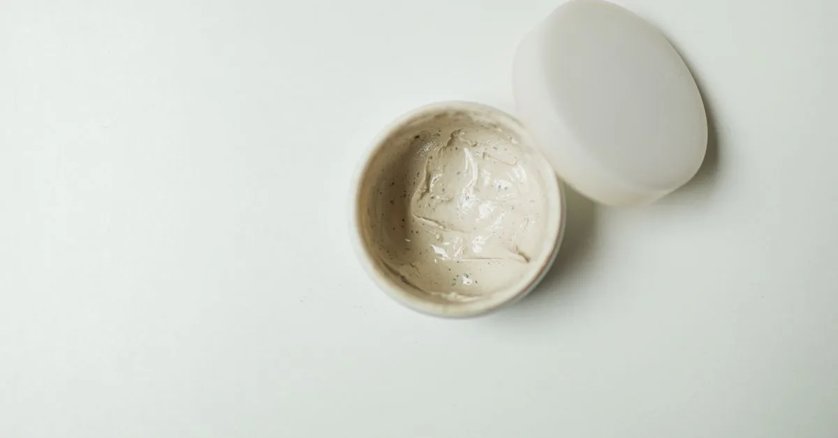 An open jar of cream photographed from above