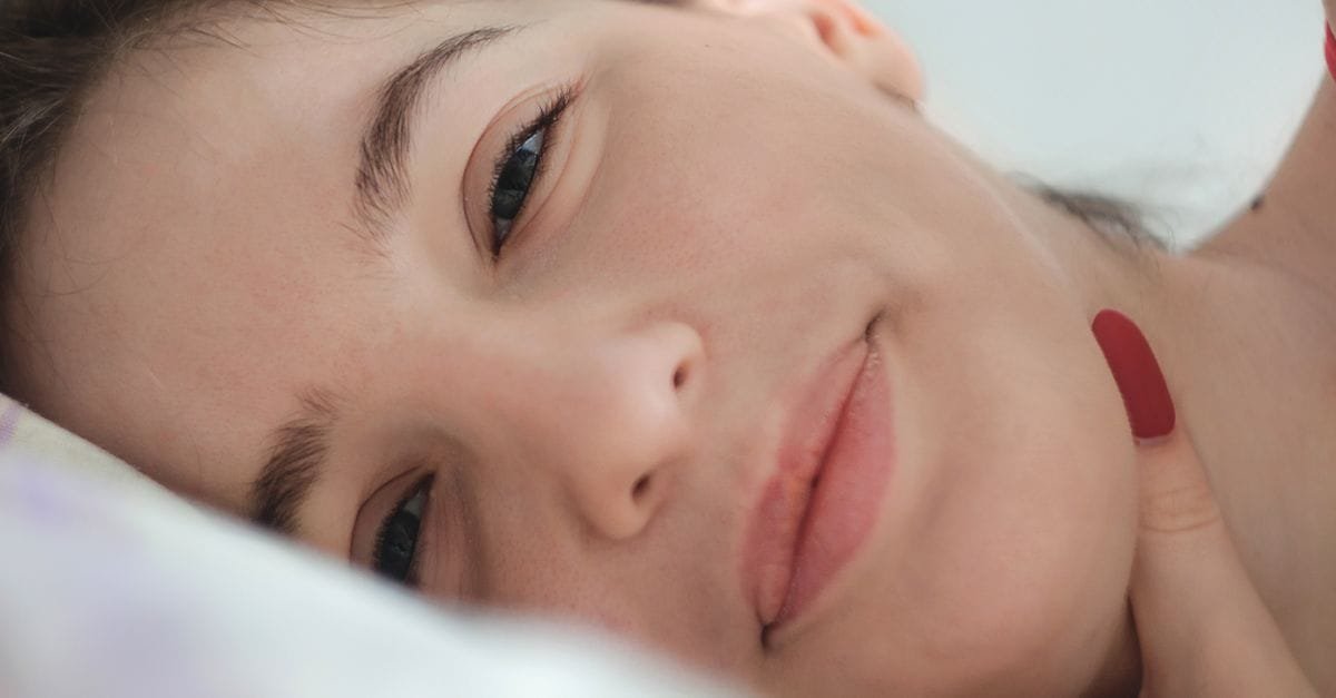 A young woman resting her cheek, looking calm