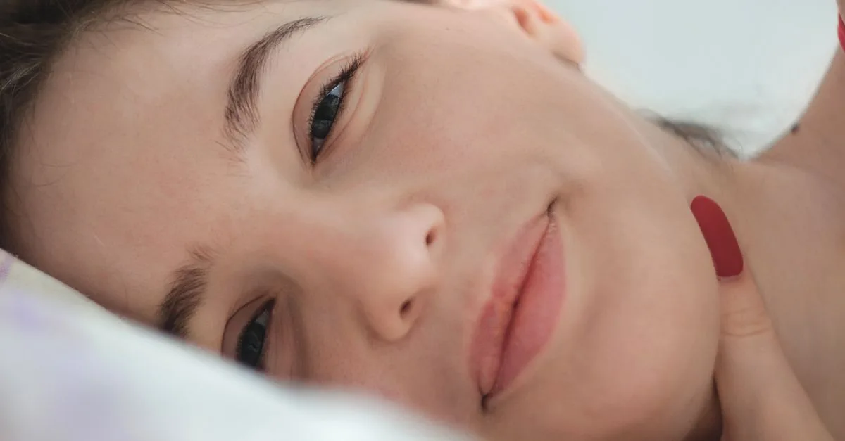 A young woman resting her cheek, looking calm