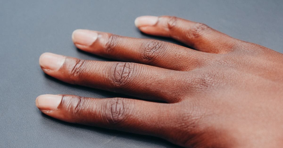 A close-up of a hand with healthy natural nails