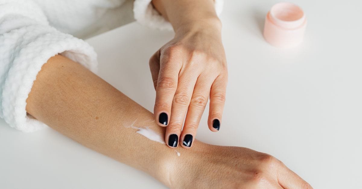 Lotion applied to a wrist over a robe