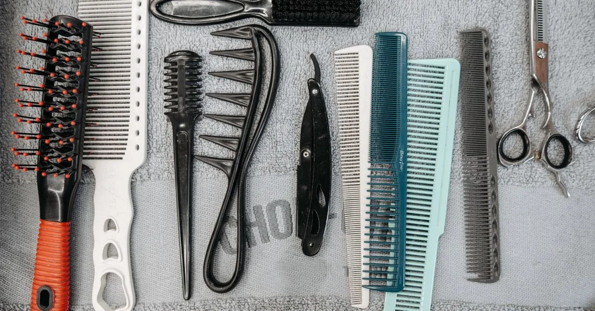Barber brushes and combs laid on a towel