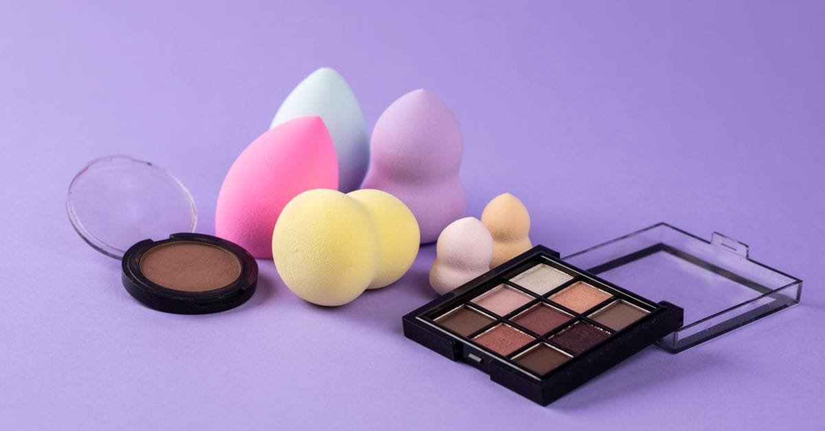 Makeup sponges and a palette on purple