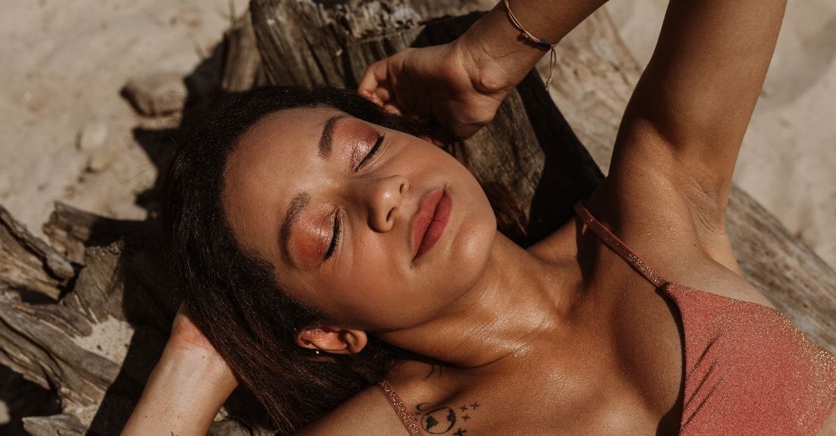 A bronzed woman relaxing in the sun