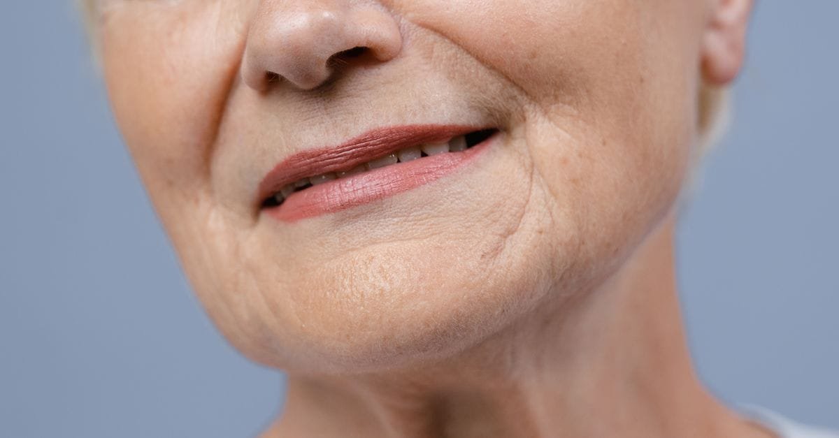 A close-up of a mature woman&rsquo;s gentle smile