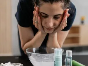A woman washing her face over a basin