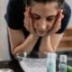 A woman washing her face over a basin