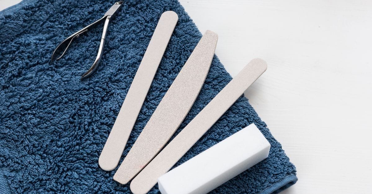 Nail files and clippers on a blue towel