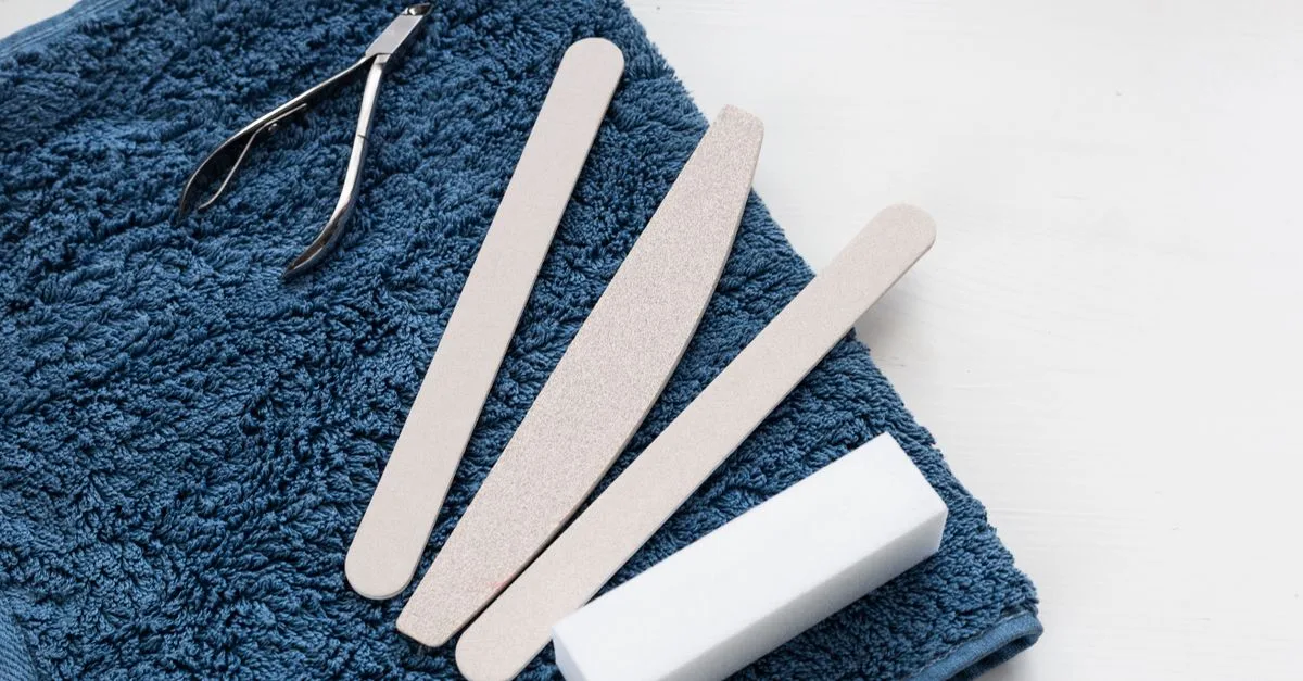 Nail files and clippers on a blue towel