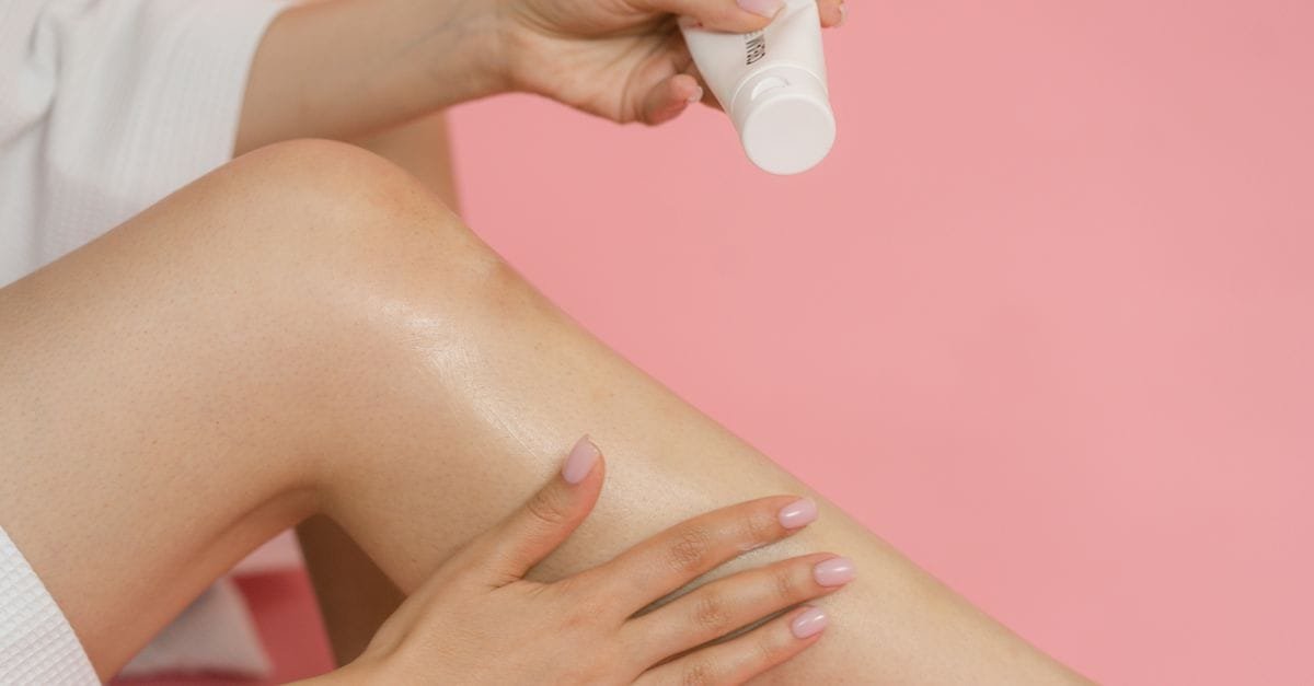 Lotion being dispensed onto a leg